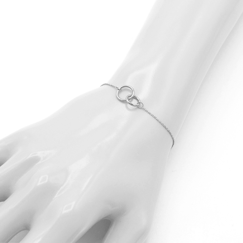 Náramek z bílého zlata s propletenými kolečky 